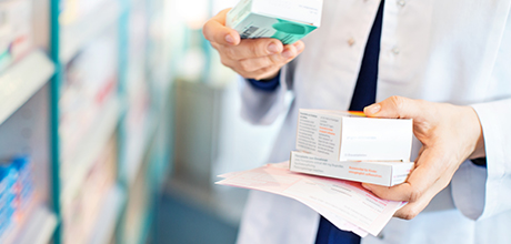 Pharmacist holding prescriptions