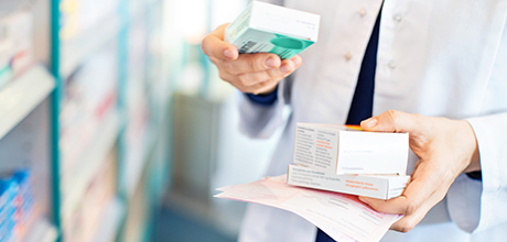 Pharmacist holding prescriptions