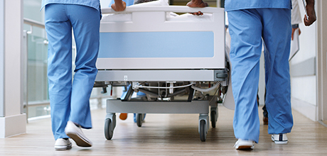 doctors pushing hospital bed