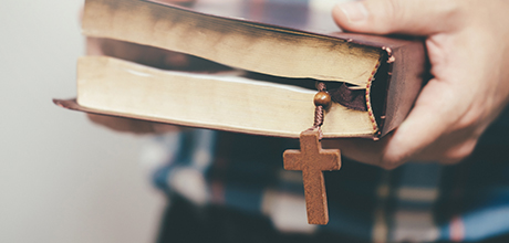 person holding religion book