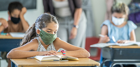 children wearing masks in the classroom