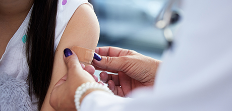 doctor putting band-aid on child's arm