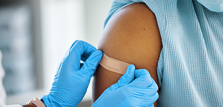 doctor putting band aid on patient