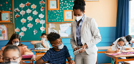 students and teacher wearing masks