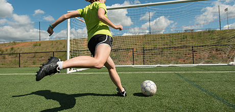 girl playing soccer
