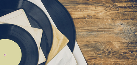 Pile of old vinyl records in paper cover