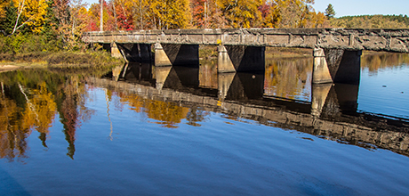 Old concrete bridge with autumn reflections