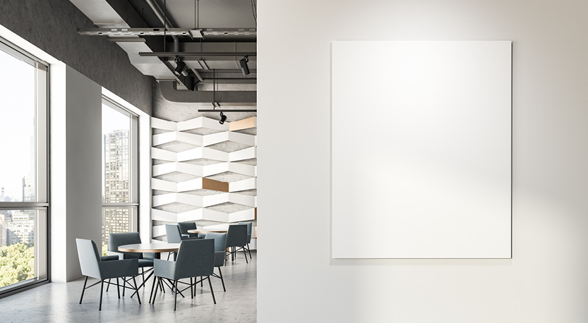 a blank poster hangs on the wall in a break room with table and chairs.