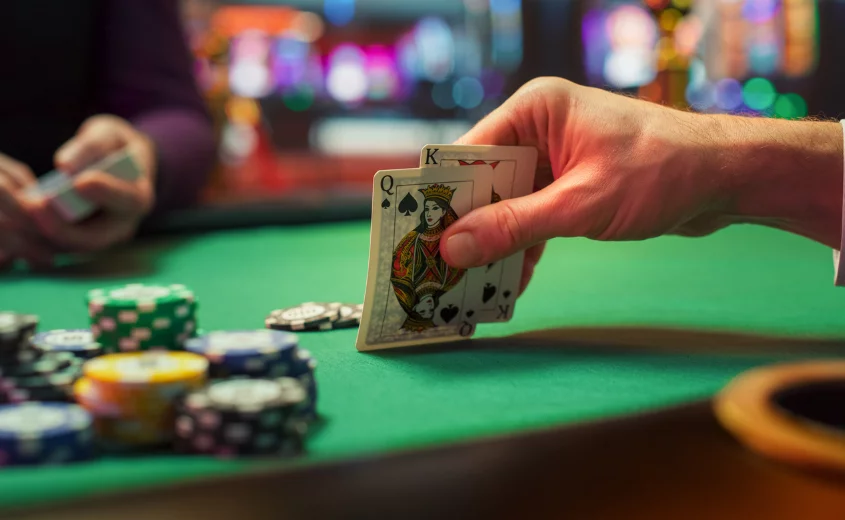 Person playing cards at casino