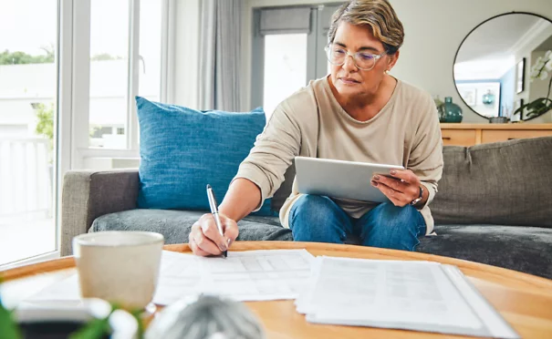 Person reviewing paperwork on a tablet