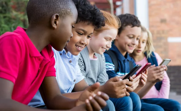 Kids looking at cell phone