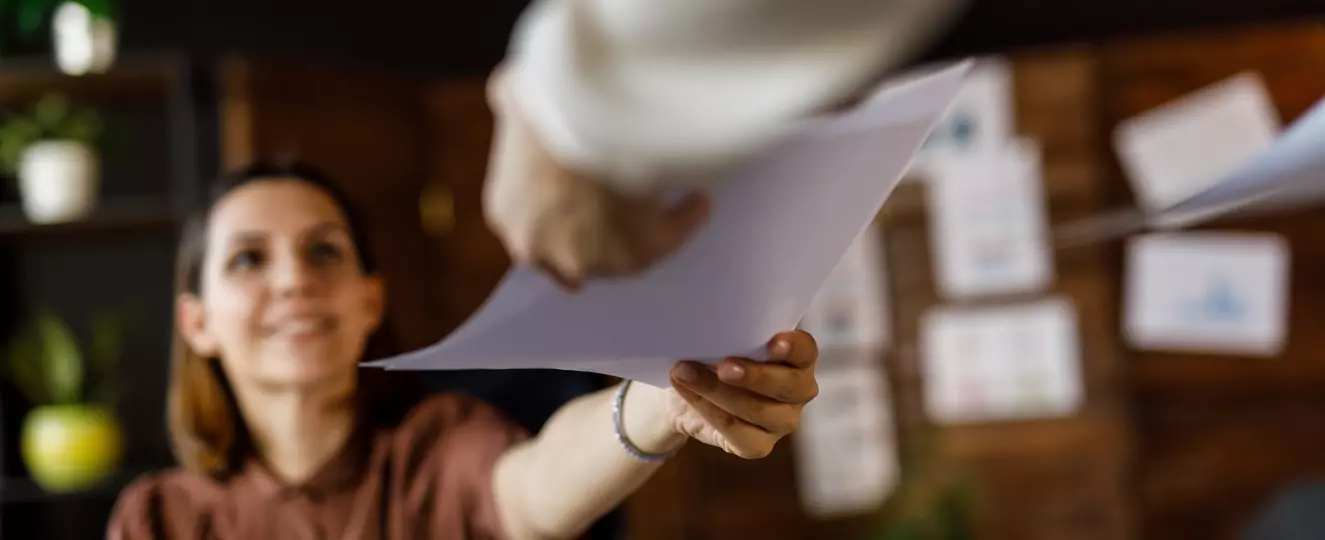 Person handing in paperwork