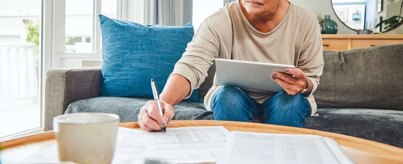 Person reviewing paperwork on a tablet