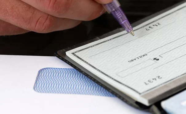 Person writing a check