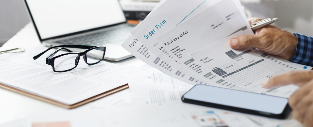 Person reviewing documents at a desk