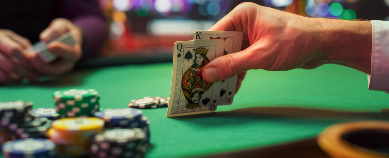 Person playing cards at casino