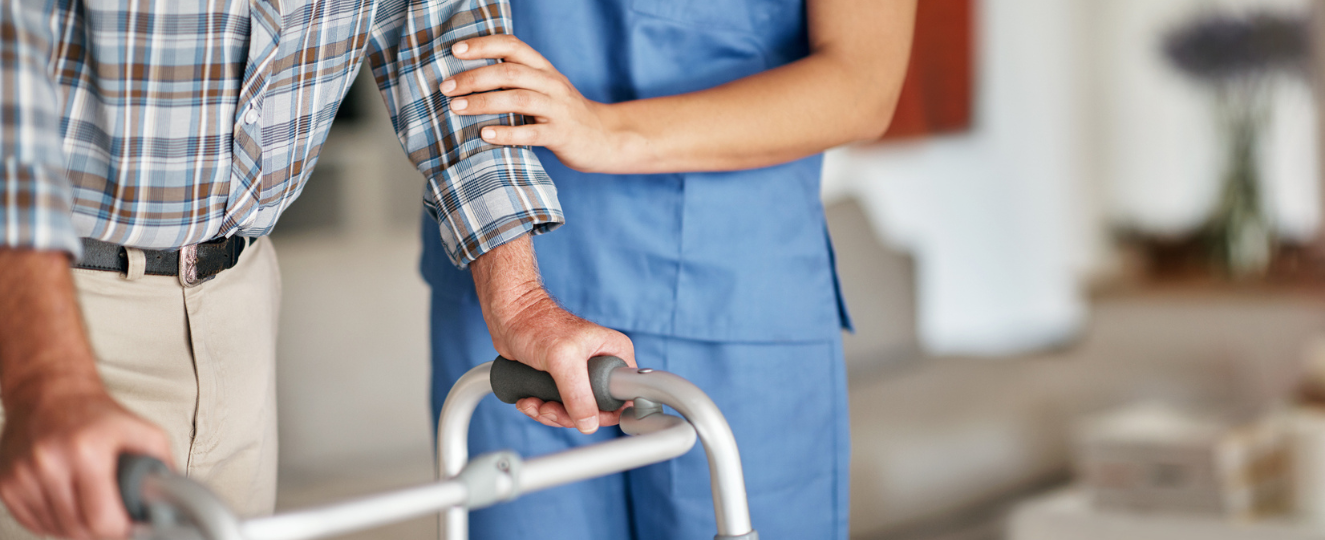 Nurse helping person with a walker