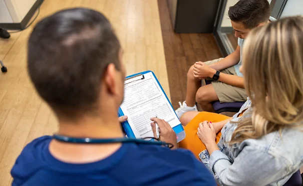 Nurse receptionist explains paperwork in lobby