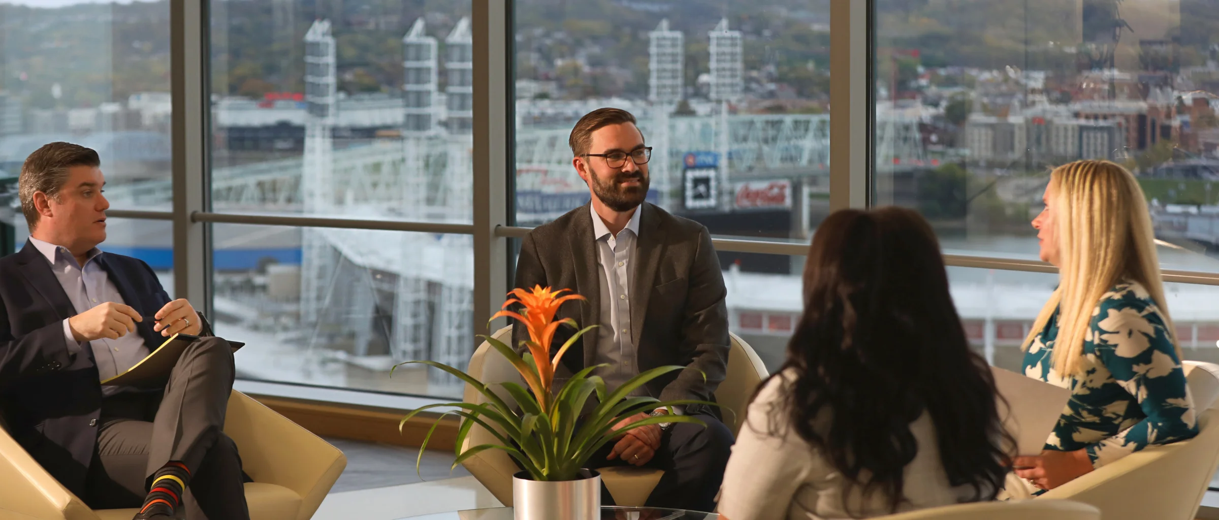 Group of people talking on seats in lobby