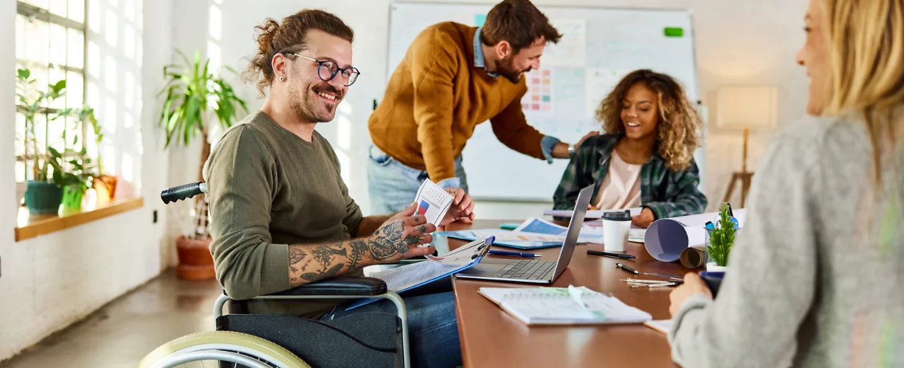 Happy people working talking to colleague in the office