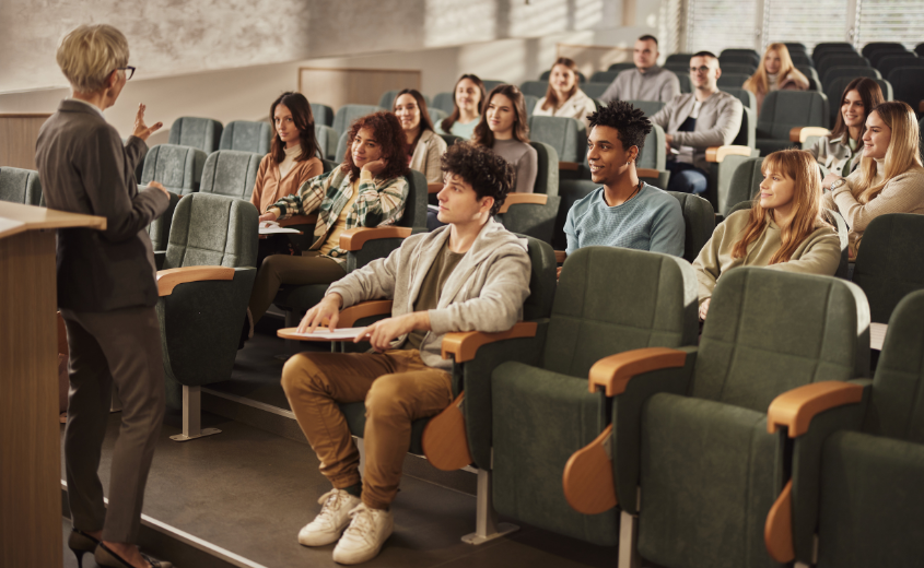 Students being lectured by a professor in an auditorium
